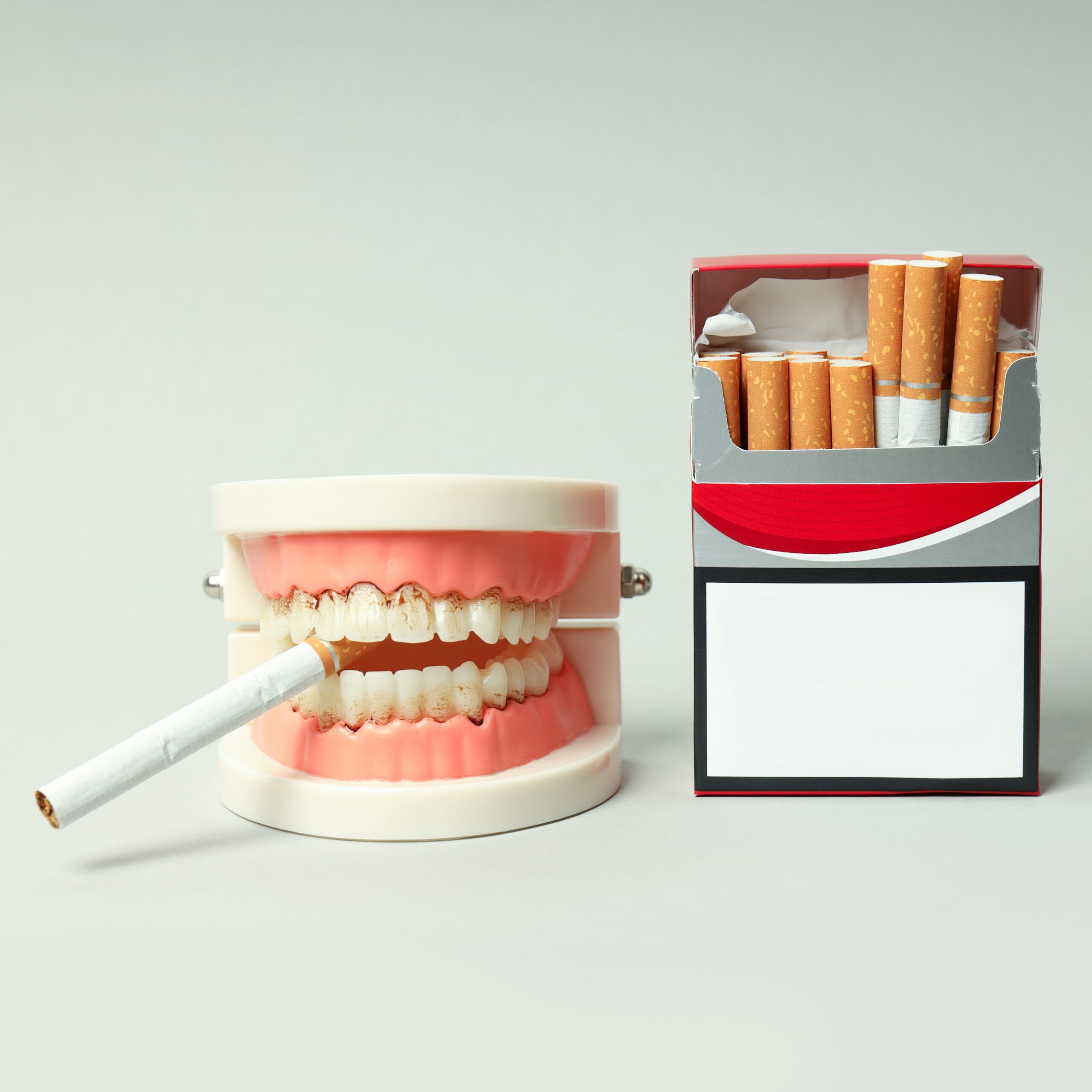 Concept of harm of smoking for teeth on light background. The Impact of Smoking and Tobacco Use on Oral Health. Risks and dangers of smoking.